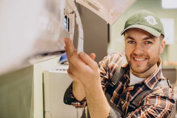 repairman doing air conditioner service 