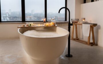 bathroom with candles bathtub filled with water
