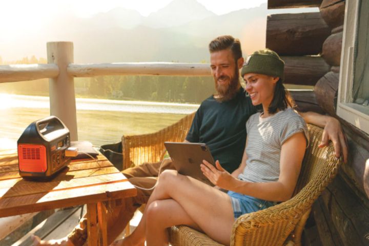 couple charging ipad with electricity generator