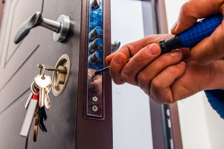 man installing door lock
