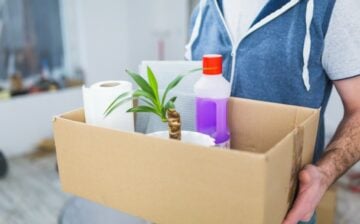 crop man carrying things in a box