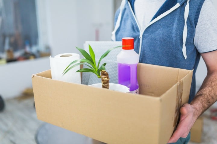 crop man carrying things box