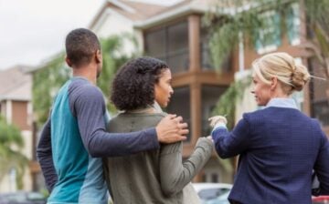 woman showing house to couple