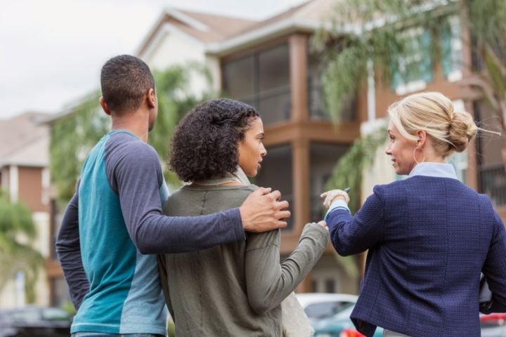 woman showing house to couple