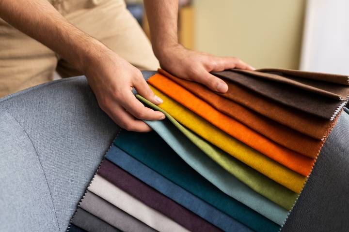 man selecting sofa fabric