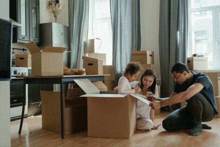 family packing moving boxes