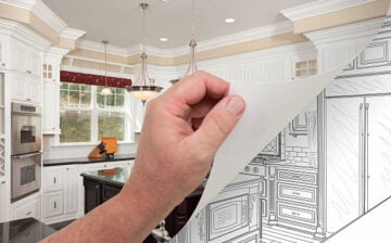 Male Hand Turning Page of Custom Kitchen Photograph to Drawing Underneath