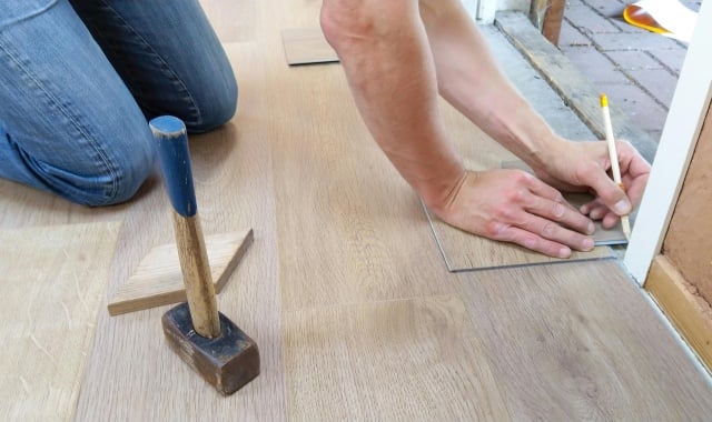 worker measures floor
