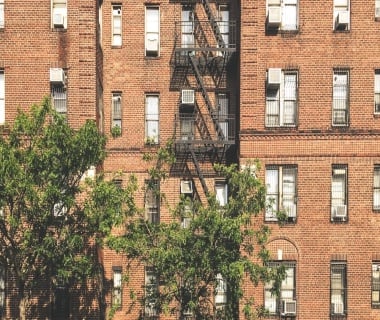 Exterior of residential building with fire escape ladders