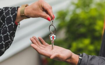 female hands a house key