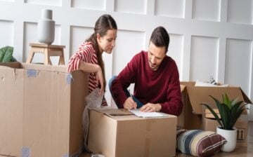 A couple is packing boxes and making inventory