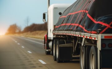 Flatbed truck hauling load.