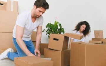 a couple is packing boxes